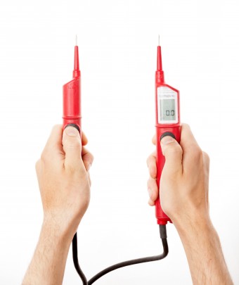Electrician hands holding red meter