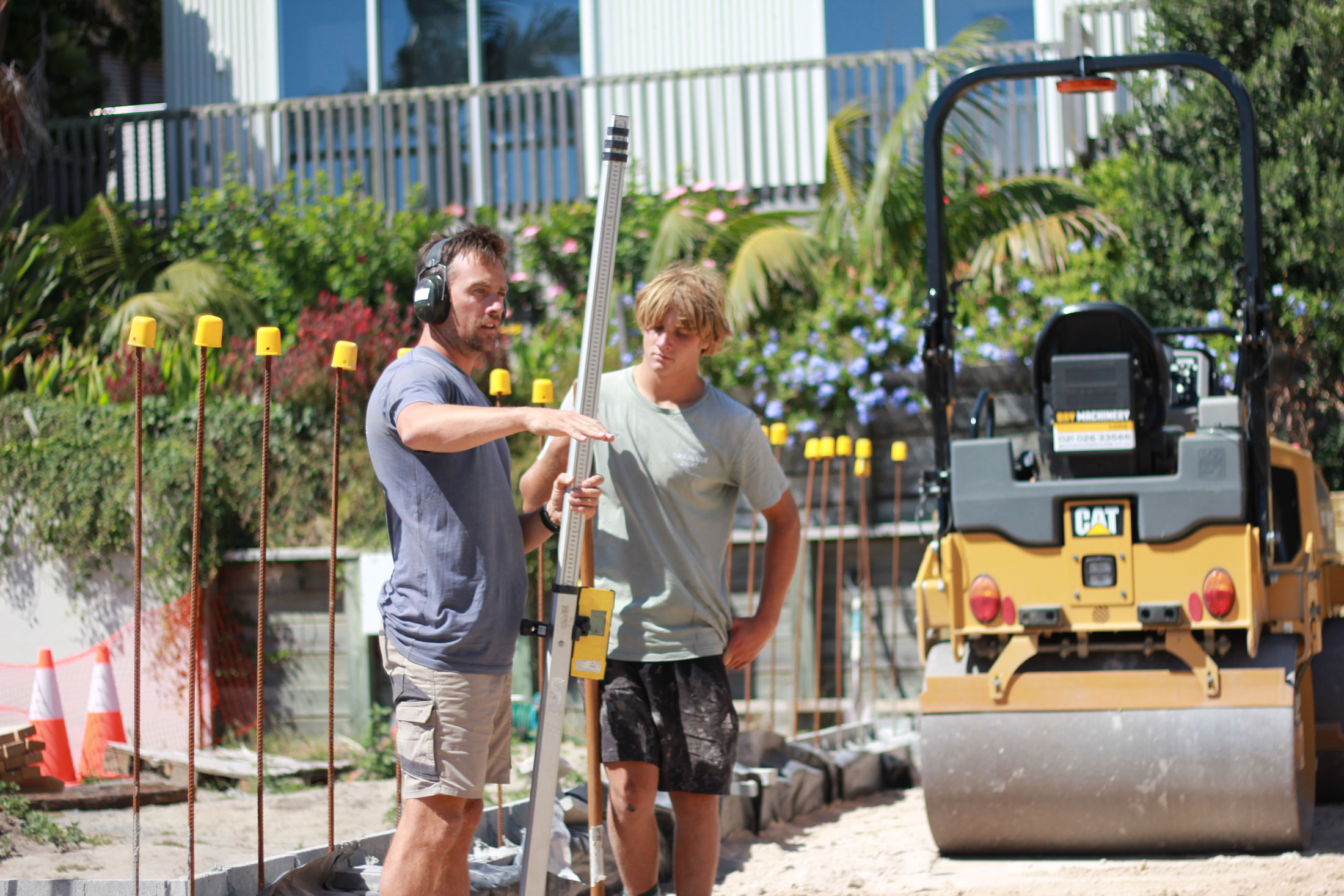 Plumber teaching apprentice on the job